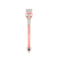 A rose gold diamond ring shown from the side on a clean white background. The ring features a round-cut diamond solitaire setting with a pavé band of smaller round diamonds along the shank.