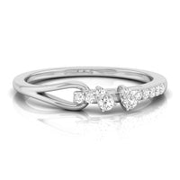 A silver-toned diamond ring with a split design featuring a pear-cut diamond center and heart-shaped diamonds on either side, set against a clean white background with a soft reflection. white gold