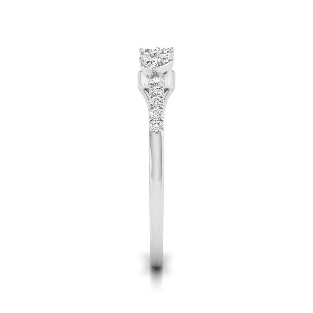 A silver-toned diamond ring with a round-cut center stone and a pavé band of smaller diamonds, shown vertically against a plain white background. white gold