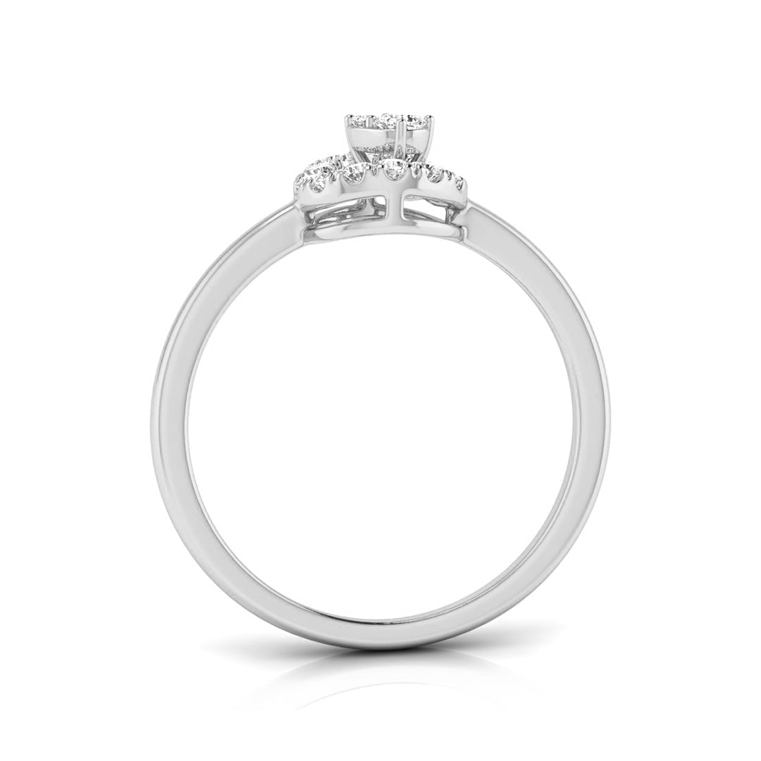 A white gold or platinum engagement ring featuring a round center stone and a small halo of round side stones, shown from a top-down view on a white background.