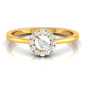 A yellow gold ring with a double halo design featuring round and marquise-cut clear stones, shown on a reflective white surface.
