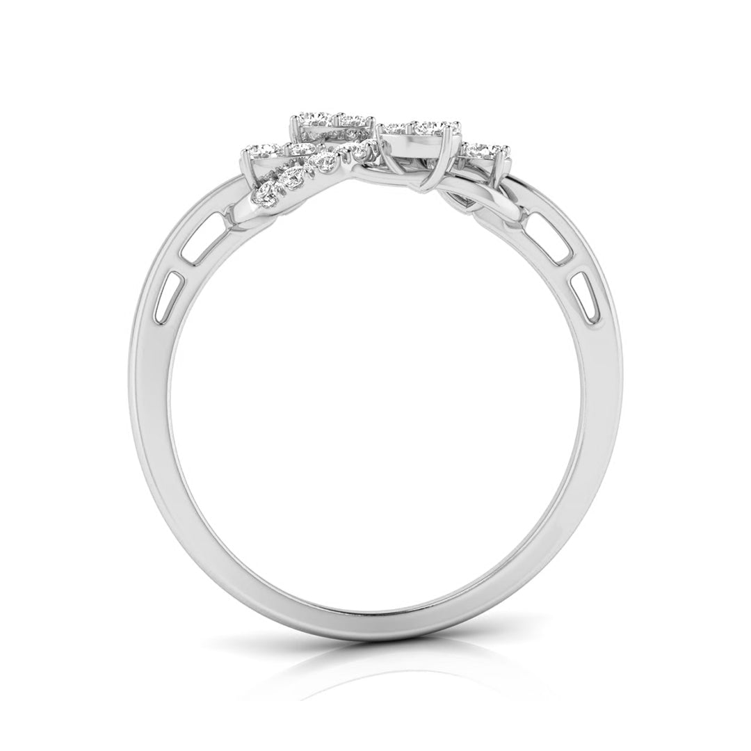 A silver-toned diamond ring shown from a side profile view, featuring a cluster of small diamonds at the top of a polished band with openwork details on the shoulders, set against a plain white background. white gold
