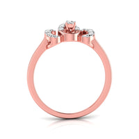 A rose gold ring with a three-stone crown design, featuring a central round gemstone and smaller side stones, shown on a clean white background.