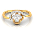 A yellow gold ring featuring a floral clover motif set with round and pear-cut diamonds, shown on a clean white background with a soft reflection.