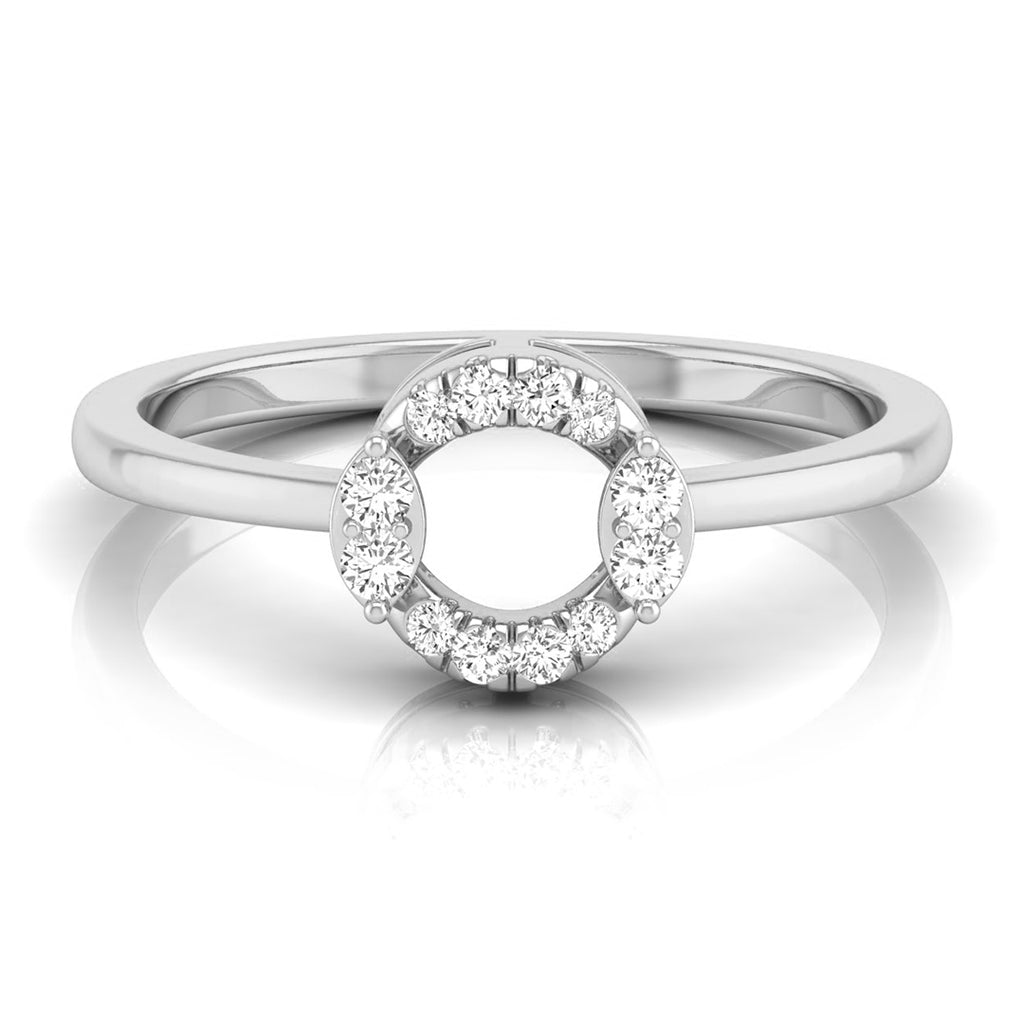 A silver-toned ring featuring a circular halo design with small clear gemstones around a larger open center, shown on a clean white background with a soft reflection. white gold