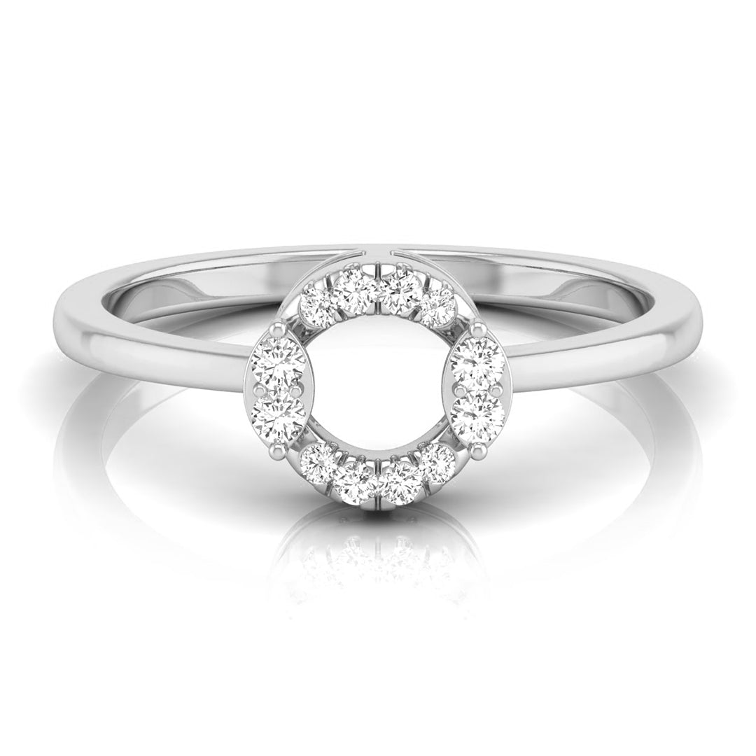 A silver-toned ring featuring a circular halo design with small clear gemstones around a larger open center, shown on a clean white background with a soft reflection. white gold