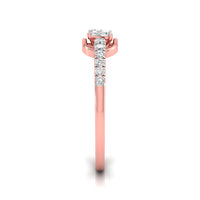 A rose gold diamond ring shown from a top-down view on a white background. The ring features a round-cut diamond center stone in a prong setting, with a pavé band of smaller round diamonds extending down the shank.