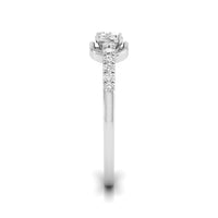 A silver-toned diamond ring with a three-stone round center and a pavé band, shown on a plain white background. white gold