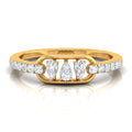 A yellow gold ring featuring three central pear-cut diamonds flanked by smaller round diamonds on the band, set against a clean white background with a soft reflection.