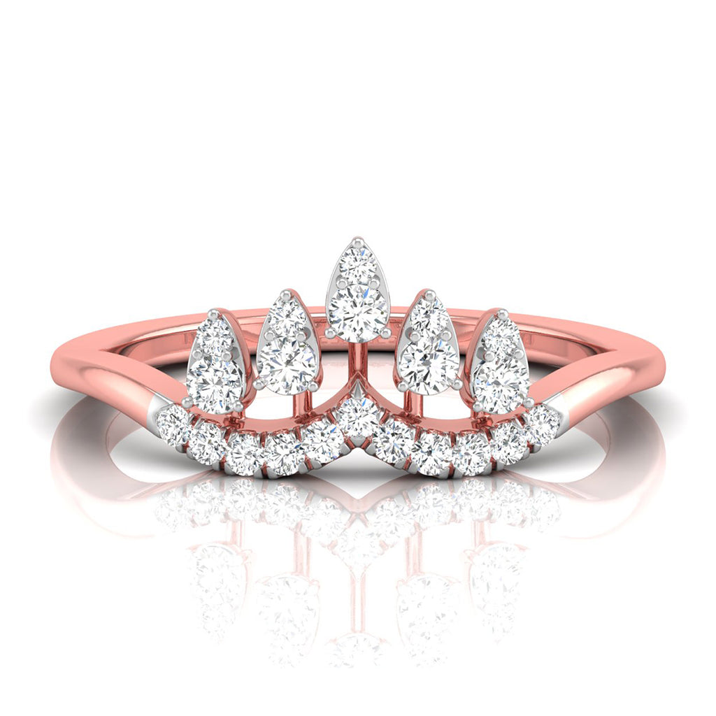 A rose gold ring with a crown-like top featuring pear-cut and round diamonds, shown on a clean white background with a soft reflection below.