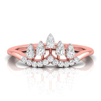 A rose gold ring with a crown-like top featuring pear-cut and round diamonds, shown on a clean white background with a soft reflection below.