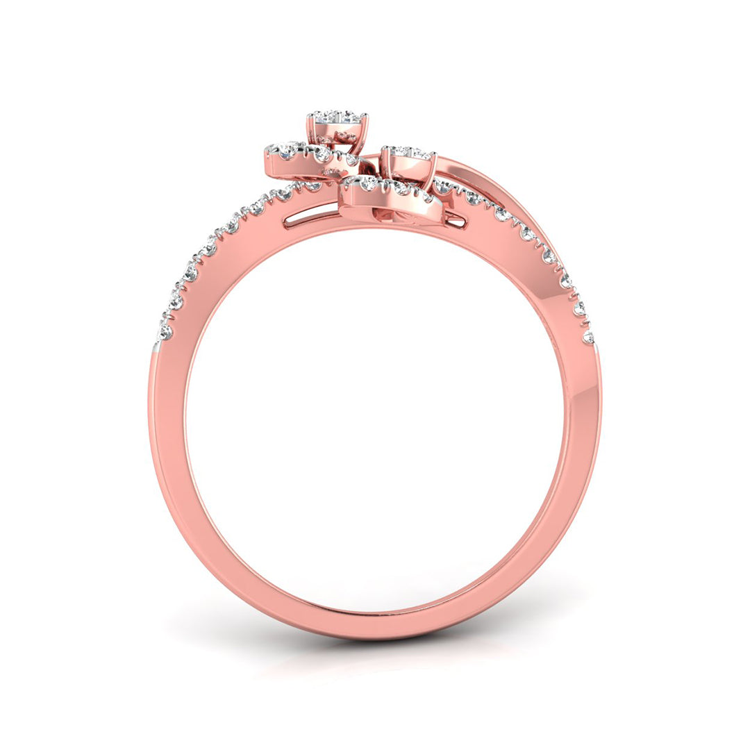 A rose gold ring with a pavé diamond band and a three-stone cluster setting on top, shown from a side angle on a white background.