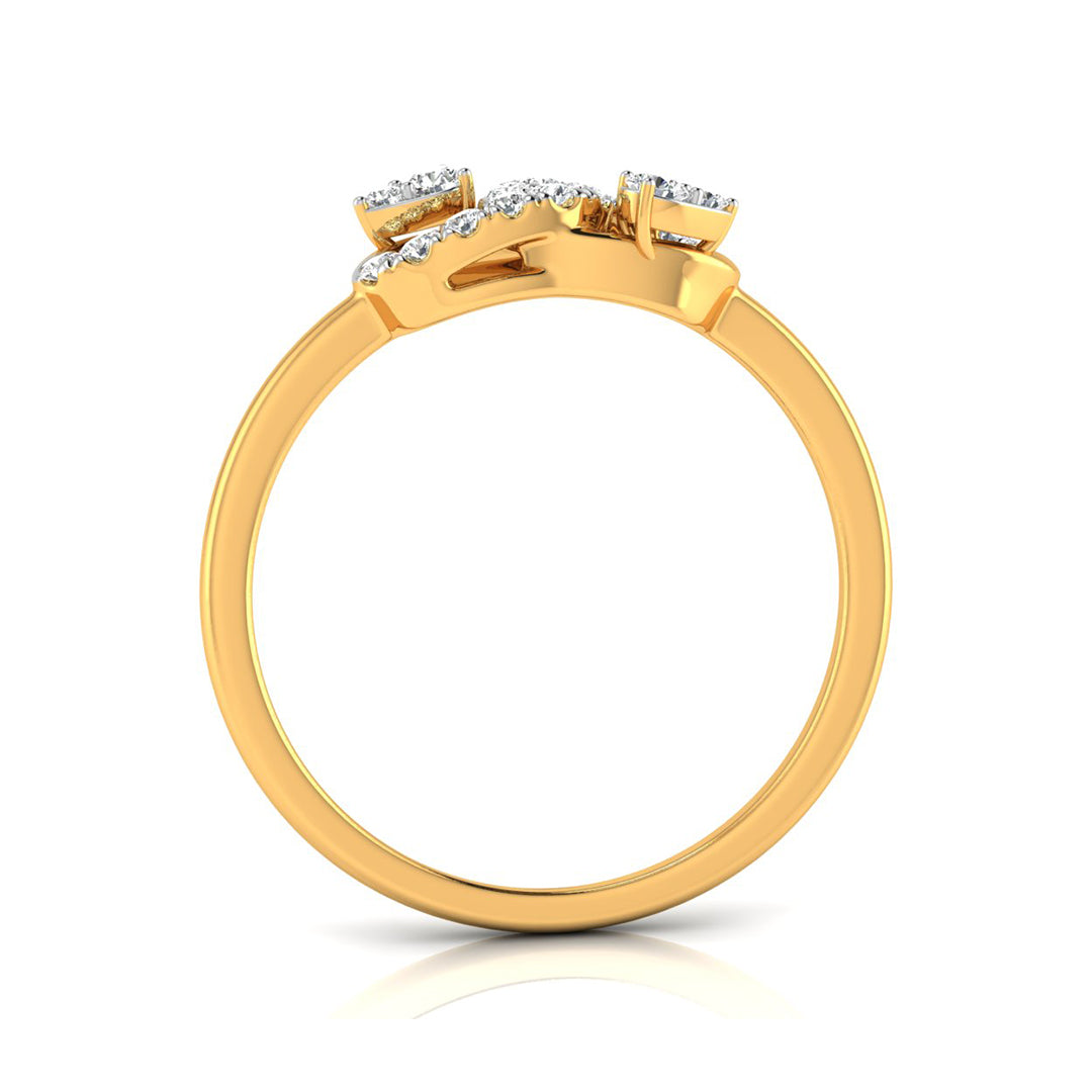 A yellow gold ring with a cluster of small clear gemstones at the top, shown from a side angle on a white background with a soft reflection.